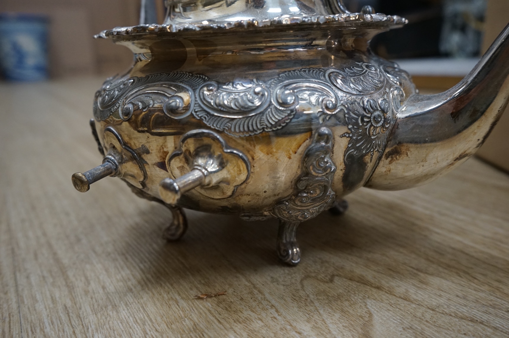 A plated tea kettle and other assorted plated ware.